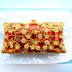Red clutch purse with gold floral embellishment